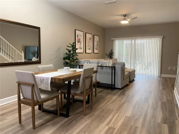 a living room with furniture a wooden floor and a window