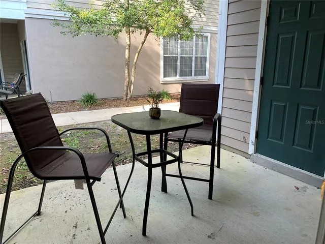 a living room with furniture a window and glass door