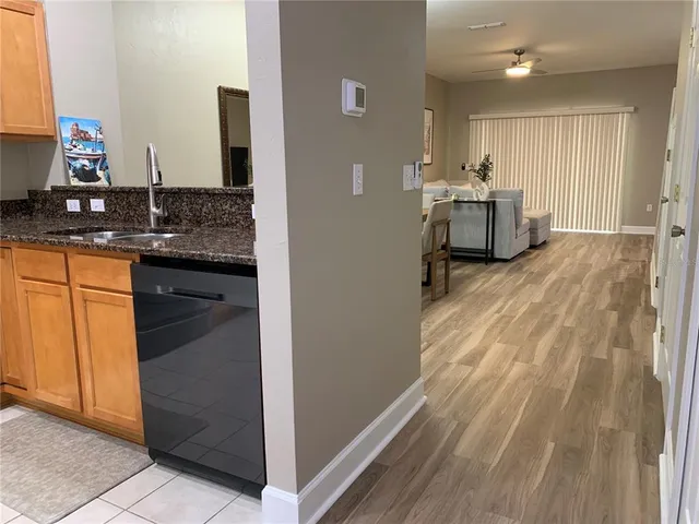 a view of kitchen with sink microwave and cabinets