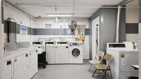 a utility room with cabinets dryer and washer
