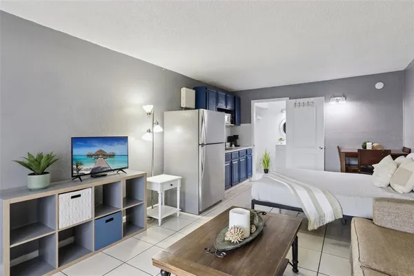 a kitchen with stainless steel appliances kitchen island granite countertop a refrigerator and a stove