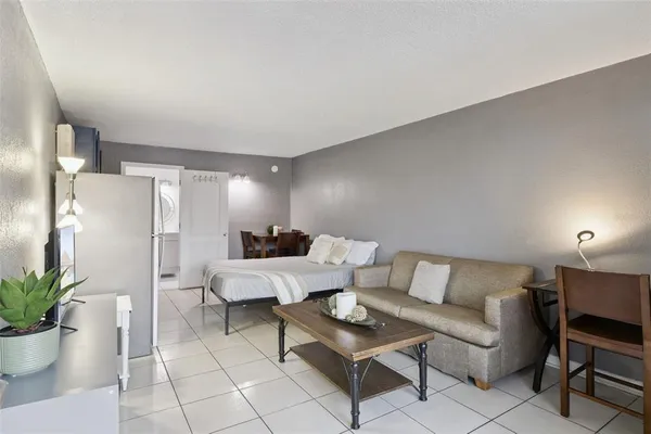 a living room with furniture and a potted plant