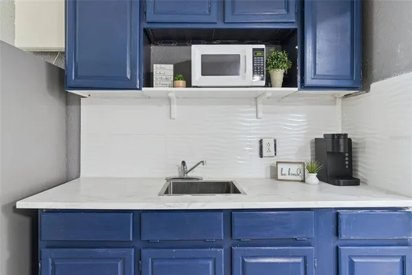 a kitchen with a sink and cabinets