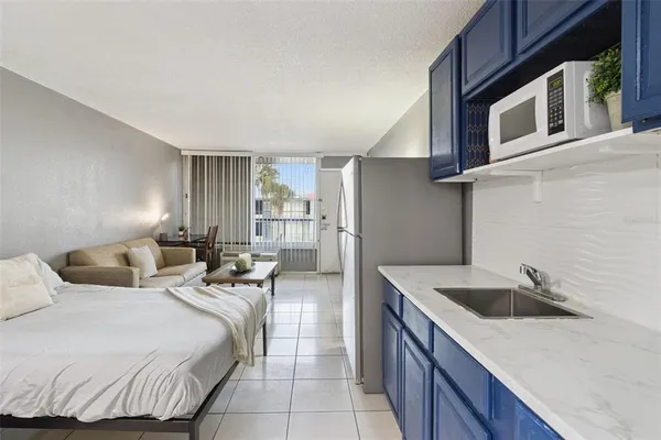 a bedroom with a bed and a stove top oven