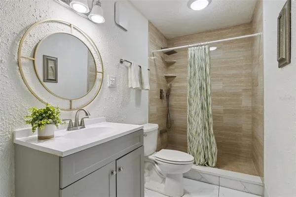 a bathroom with a sink toilet and a mirror
