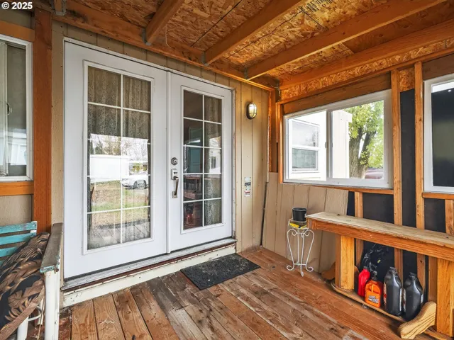 a view of porch with a black and white chairs