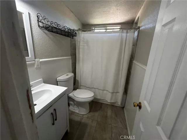a bathroom with a toilet a sink and shower