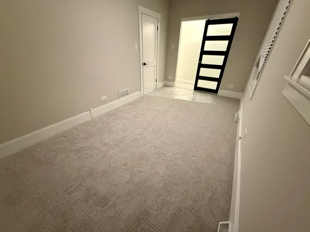 an empty room with windows and closet