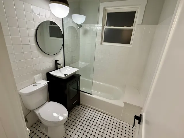 a bathroom with a sink toilet and a mirror