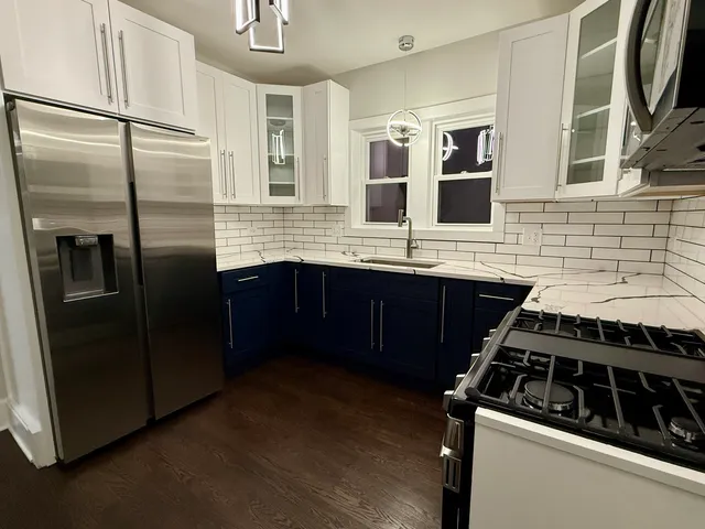 a kitchen with stainless steel appliances granite countertop a refrigerator and a sink