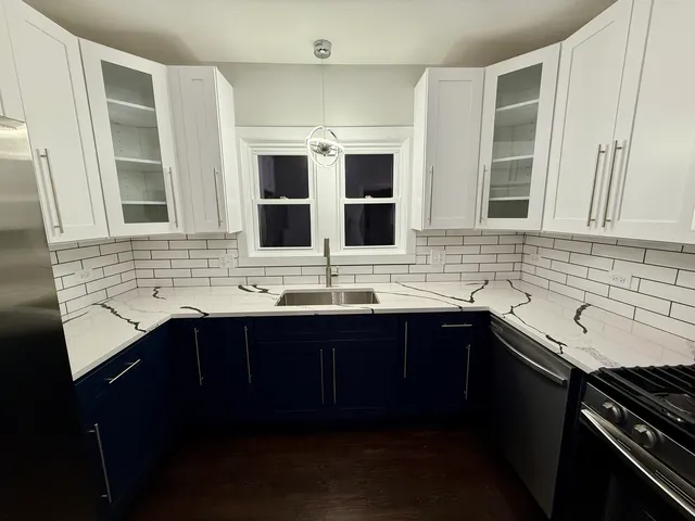 a kitchen with a sink and cabinets