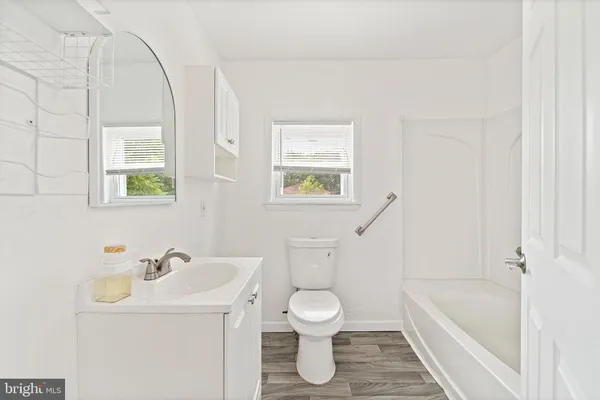 a bathroom with a sink a toilet and a bathtub