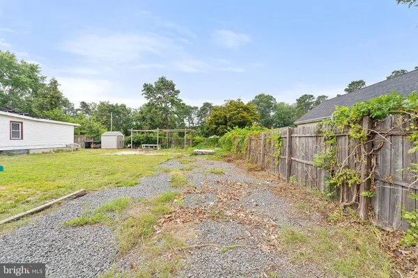 a view of a house with a backyard and a small pool