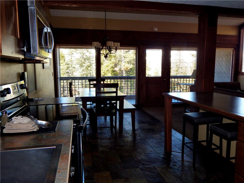 57 Fuller Placer Road, Unit 1B Breckenridge, CO 80424 - Photo 8 of 19 a view of a dining room with furniture window and wooden floor