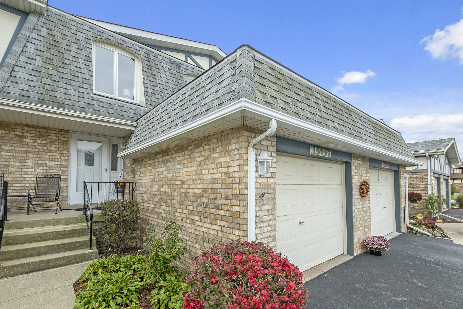 a front view of a house with a garden