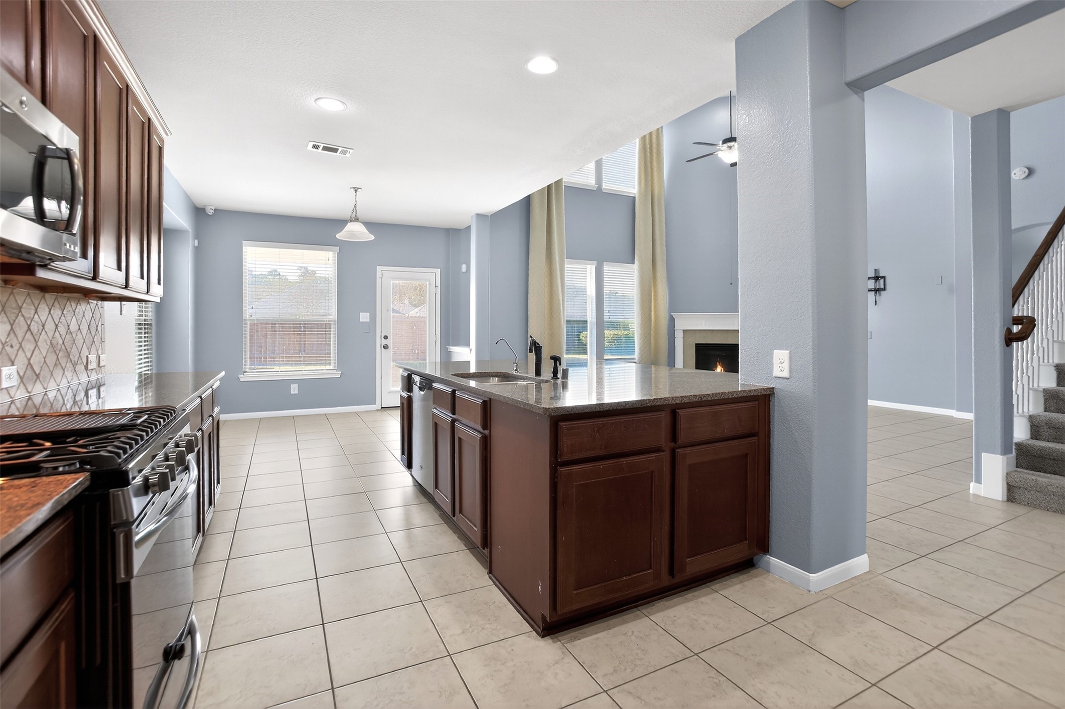 25315 Terrain Park Drive Spring, TX 77373 - Photo 11 of 47 a kitchen with stainless steel appliances granite countertop a stove and a refrigerator