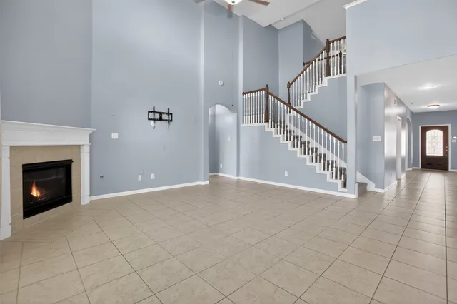 a view of an empty room with a ceiling fan