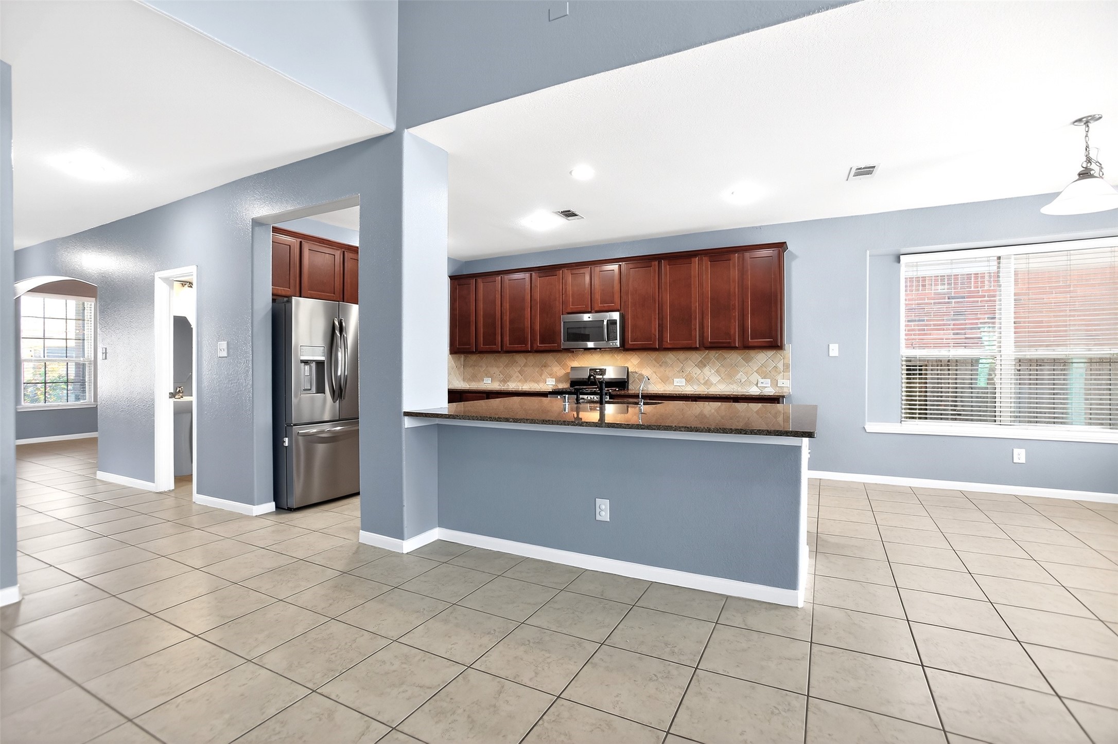 25315 Terrain Park Drive Spring, TX 77373 - Photo 14 of 50 a kitchen with stainless steel appliances granite countertop a refrigerator and a sink