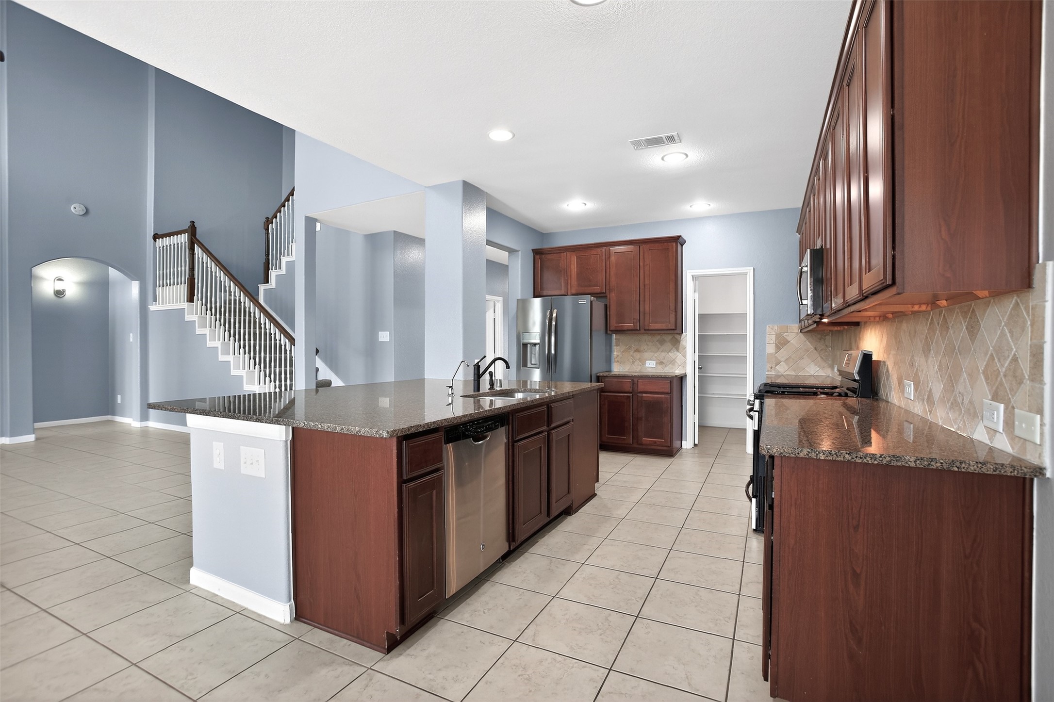 25315 Terrain Park Drive Spring, TX 77373 - Photo 18 of 50 a large kitchen with stainless steel appliances and a sink