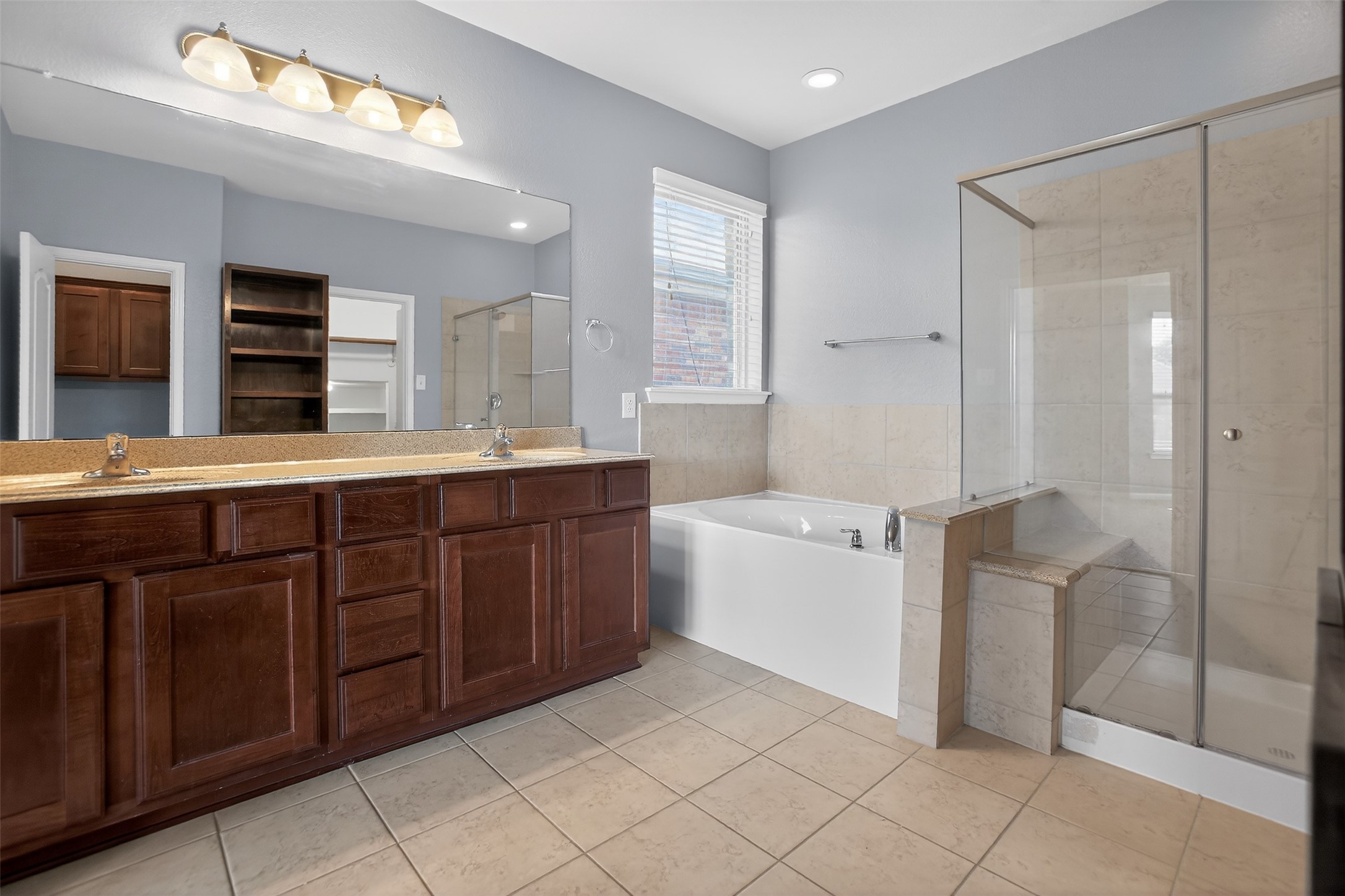25315 Terrain Park Drive Spring, TX 77373 - Photo 19 of 47 a spacious bathroom with a granite countertop sink mirror and a bathtub