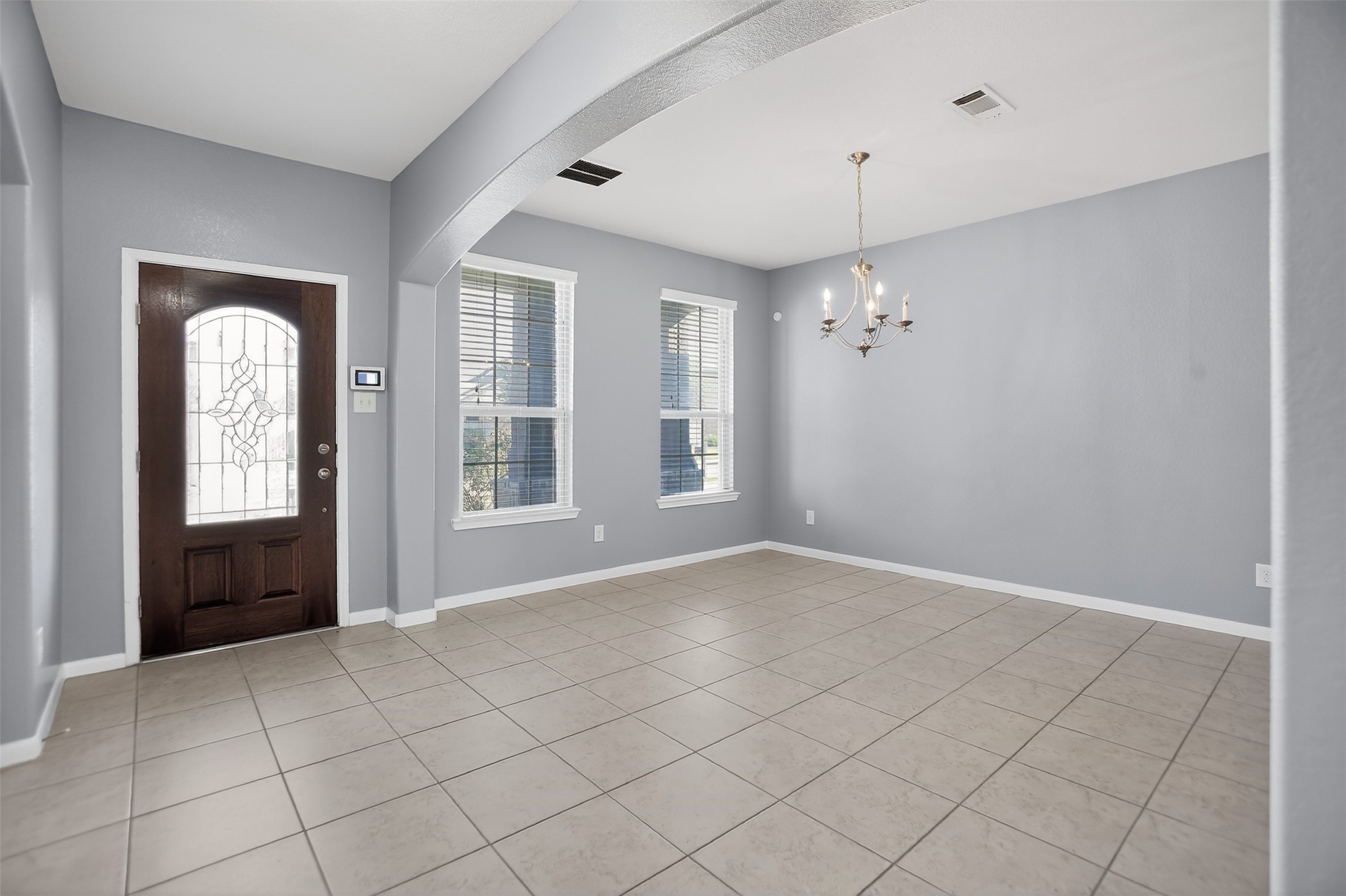 25315 Terrain Park Drive Spring, TX 77373 - Photo 7 of 50 a view of an empty room with window and chandelier fan