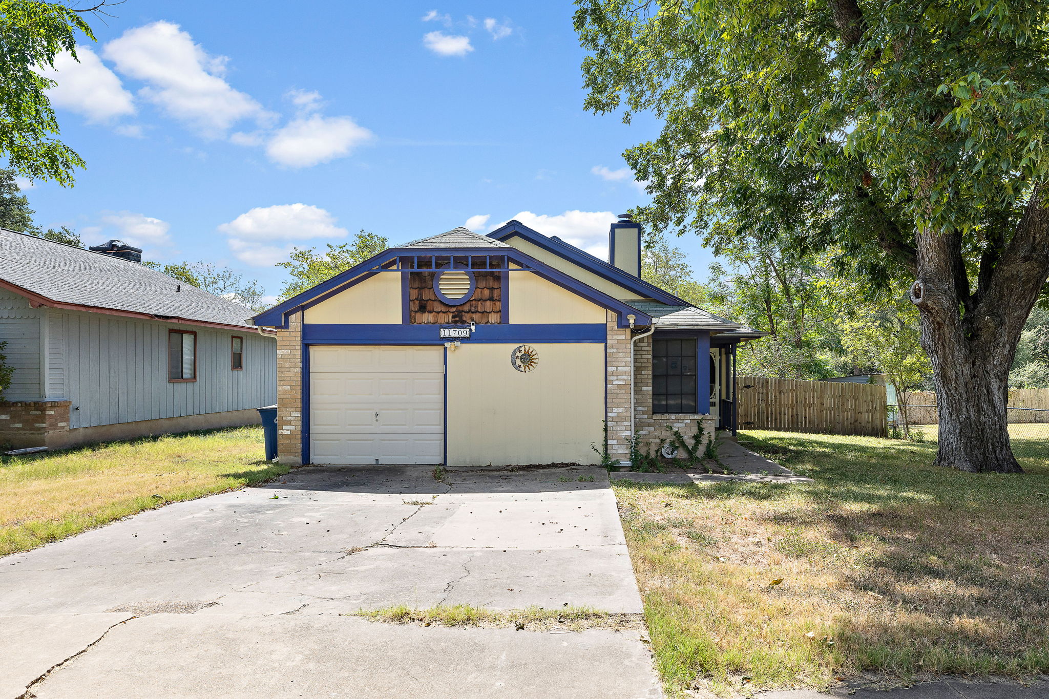 11709 Rotherham Drive Austin, TX 78753 - Photo 2 of 25 A charming single-story residence with an attached garage, mature landscaping, and a fenced backyard.