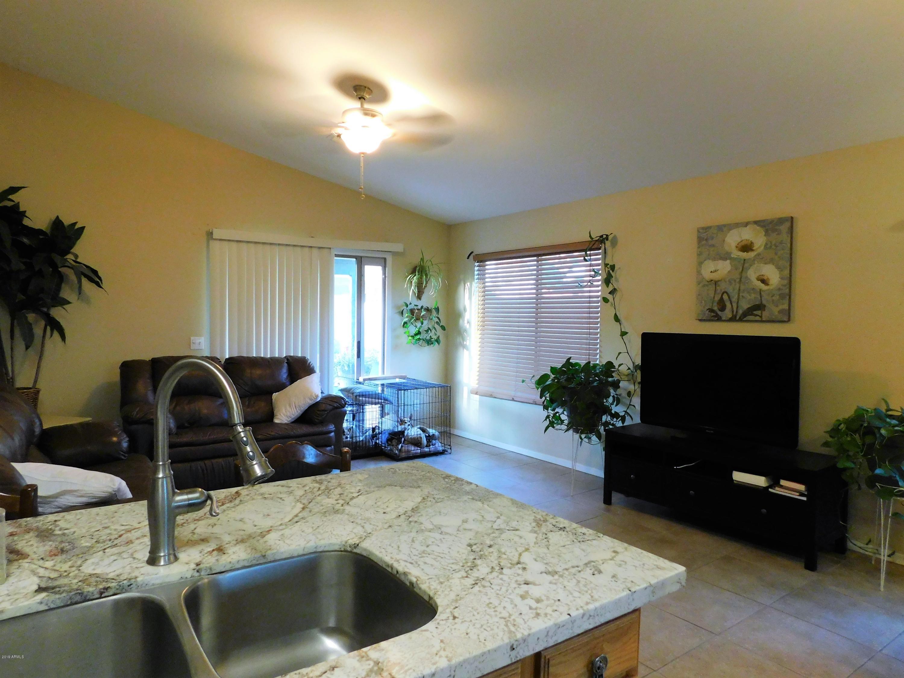 15814 West Jackson Street Goodyear, AZ 85338 - Photo 12 of 18 a living room with furniture and a flat screen tv