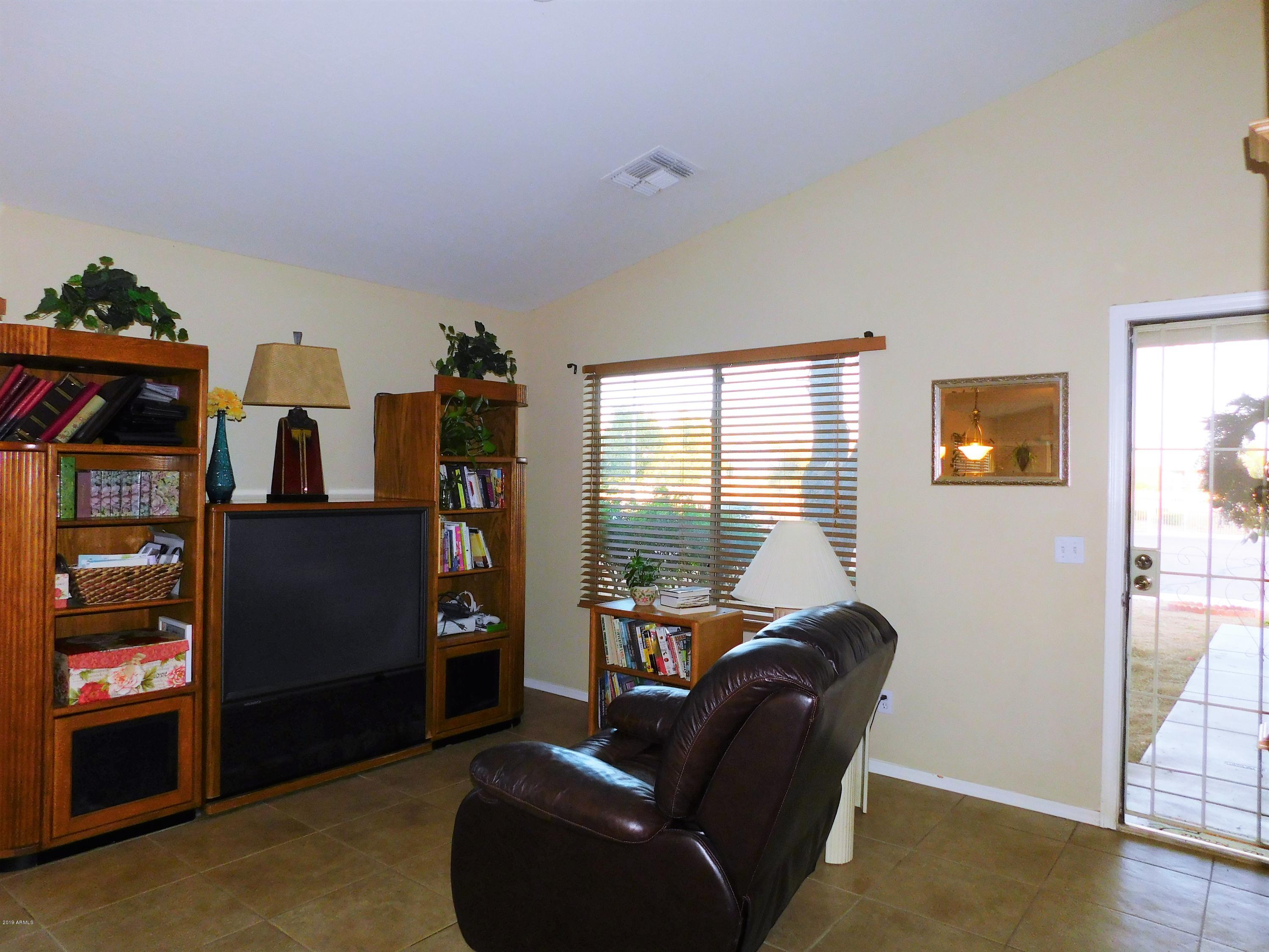 15814 West Jackson Street Goodyear, AZ 85338 - Photo 2 of 18 a living room with furniture and a window