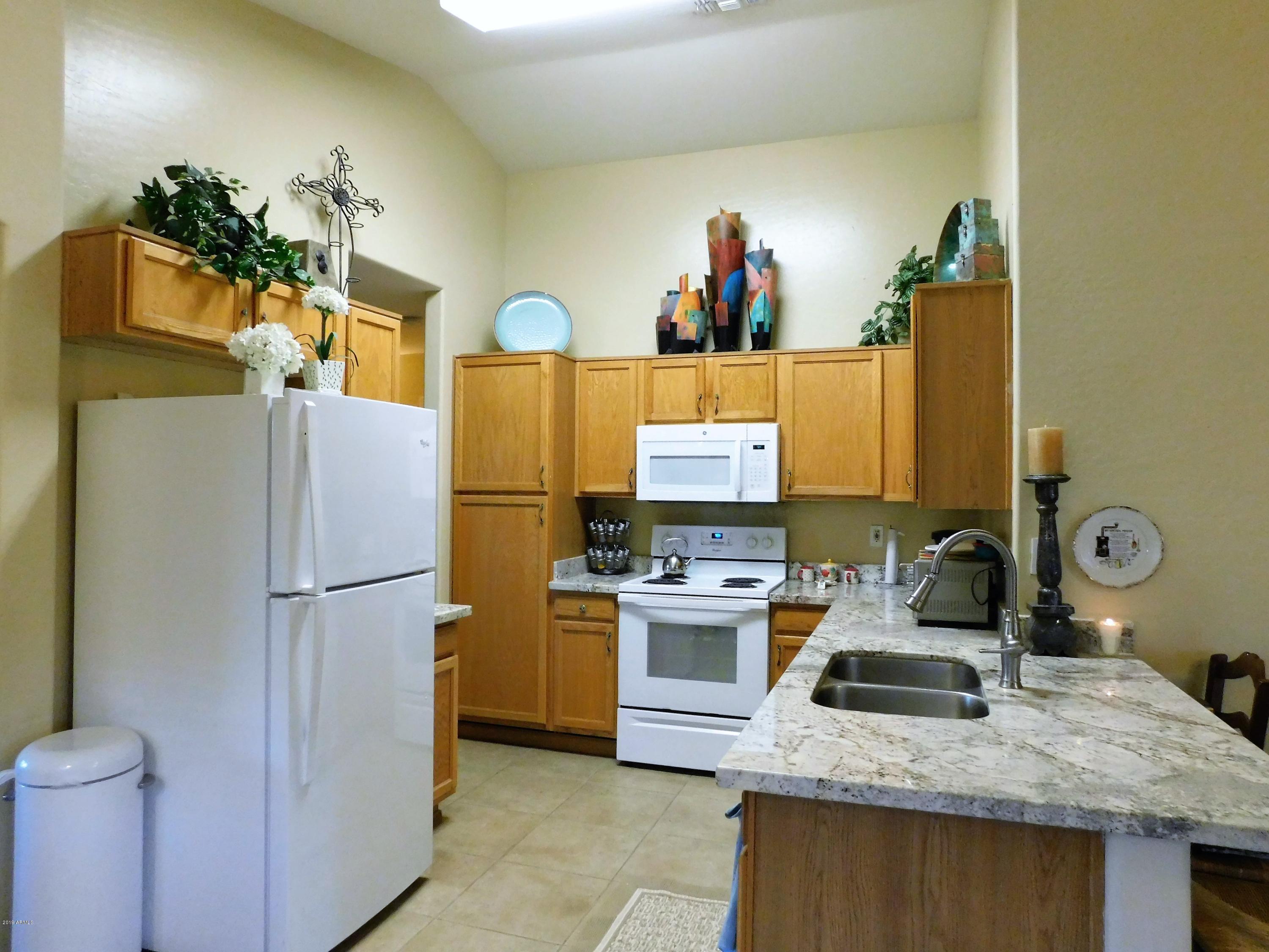 15814 West Jackson Street Goodyear, AZ 85338 - Photo 5 of 18 a kitchen with refrigerator and sink