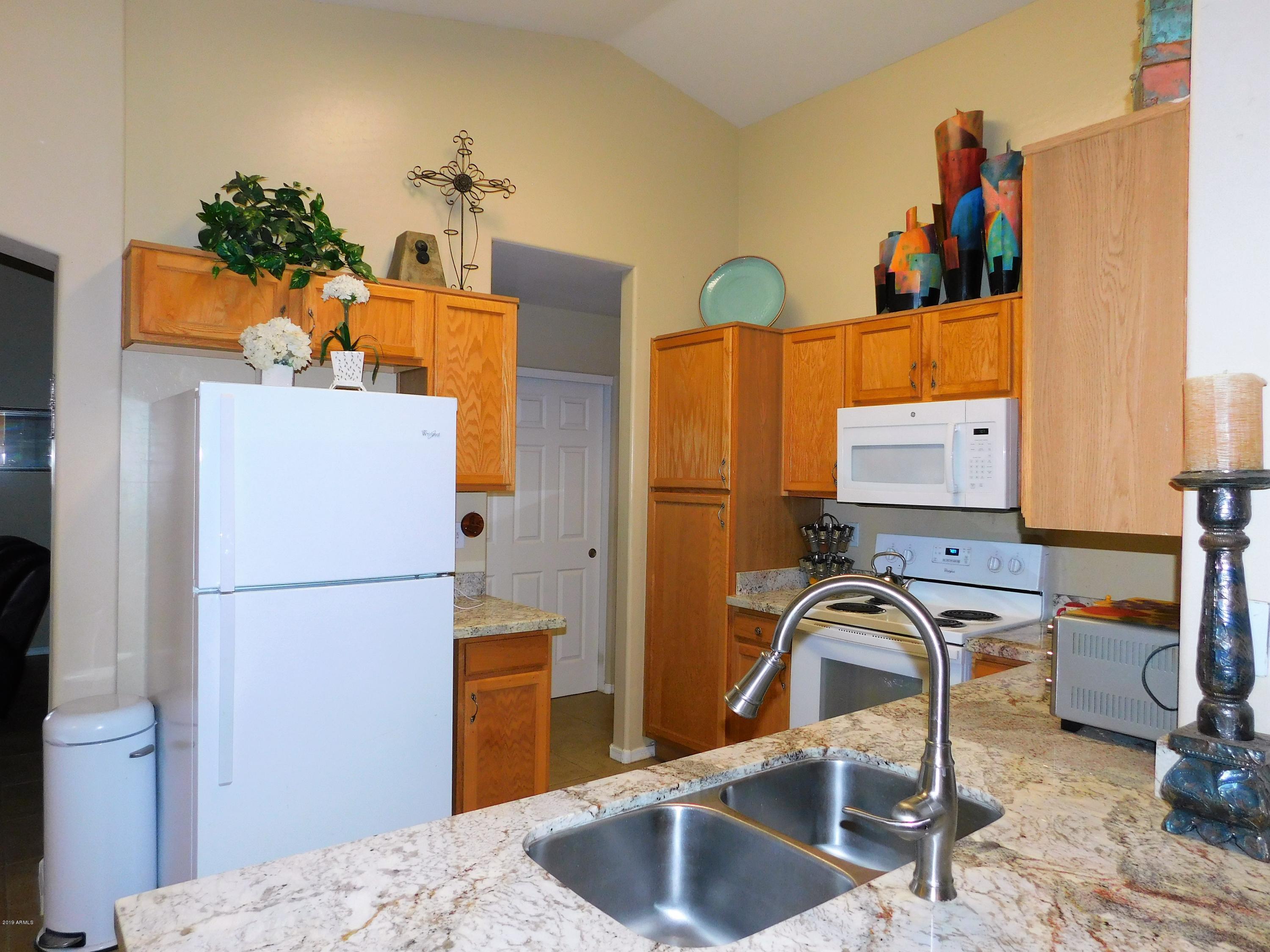 15814 West Jackson Street Goodyear, AZ 85338 - Photo 6 of 18 a kitchen with a refrigerator and a sink