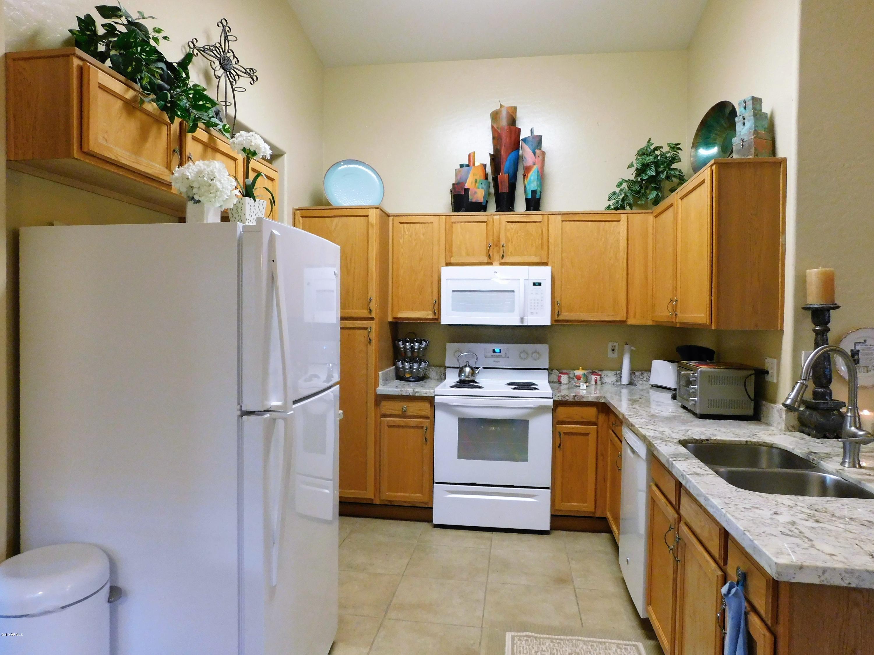 15814 West Jackson Street Goodyear, AZ 85338 - Photo 7 of 18 a kitchen with stainless steel appliances granite countertop a sink stove and refrigerator