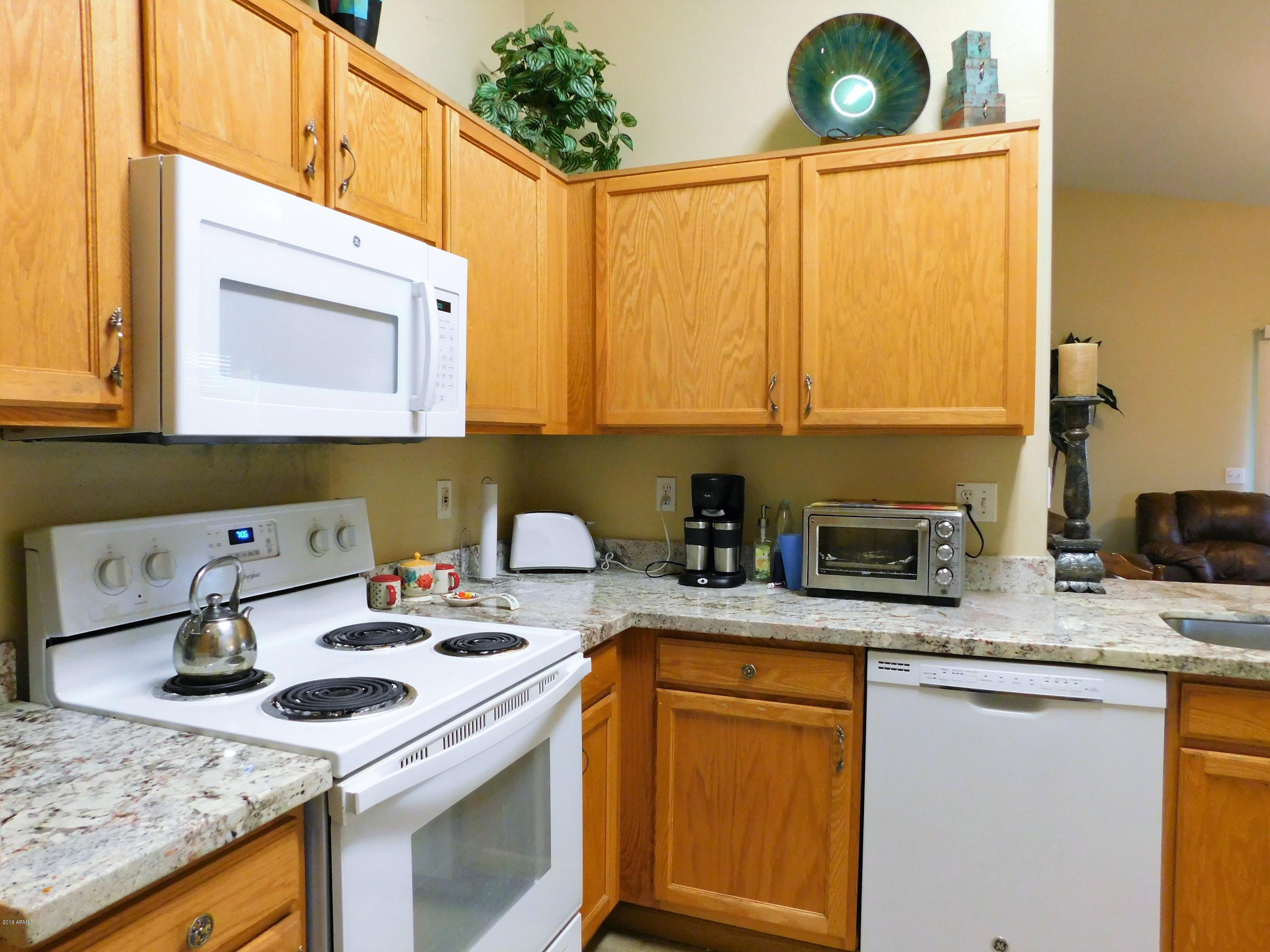 15814 West Jackson Street Goodyear, AZ 85338 - Photo 8 of 18 a kitchen with stainless steel appliances granite countertop a sink stove and cabinets