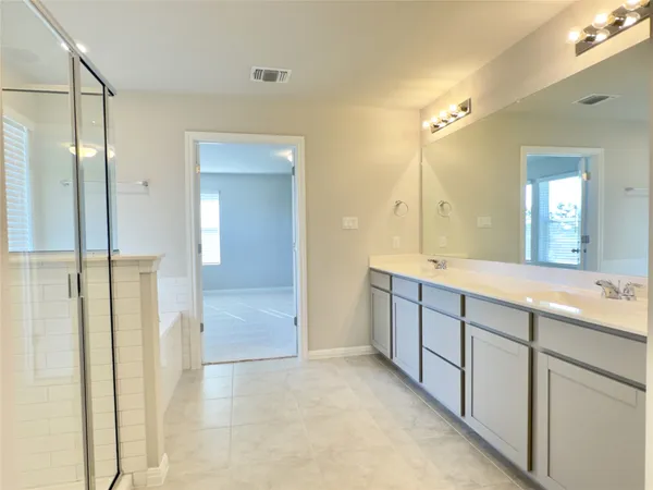 a bathroom with a double vanity sink and mirror