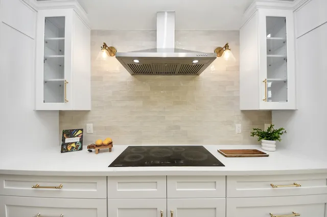 a large kitchen with stainless steel appliances a large island in the center