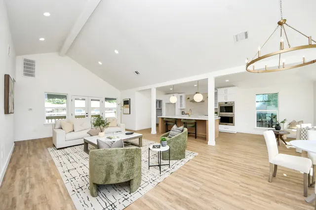 a living room with furniture and a wooden floor