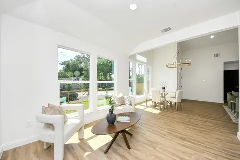 a living room with fireplace furniture and a large window