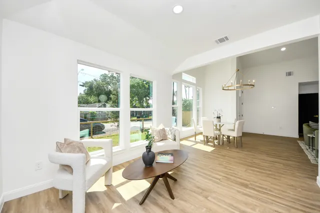 a living room with fireplace furniture and a large window