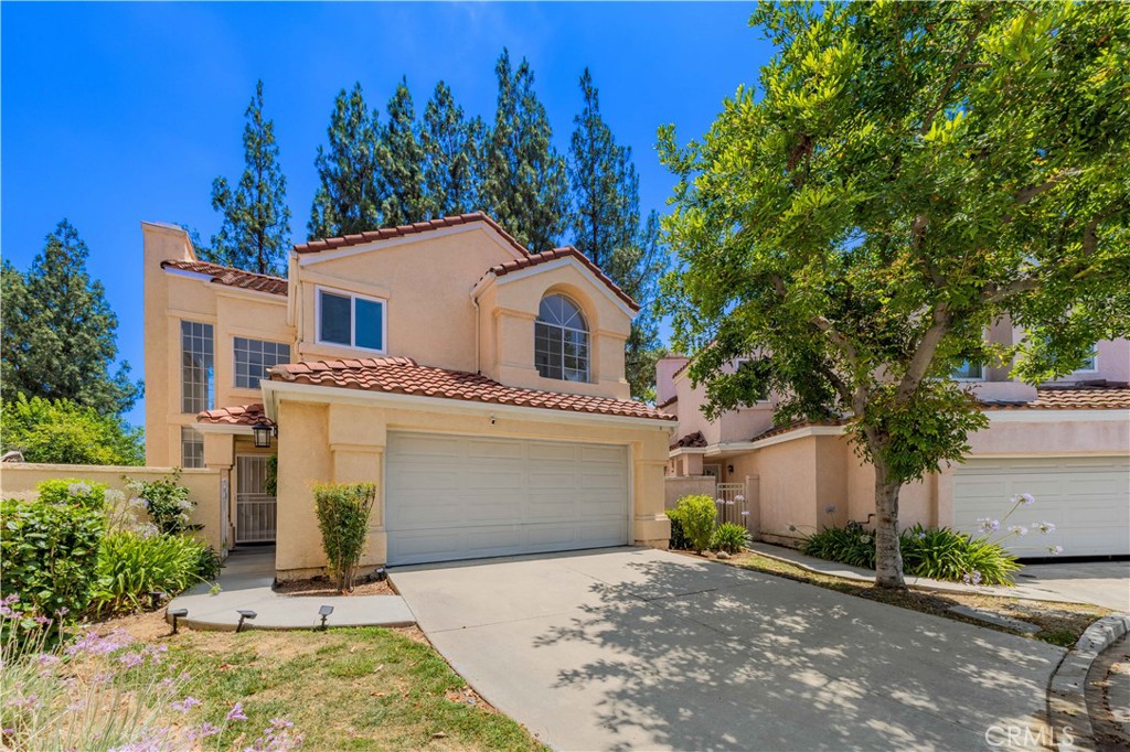 6 Calle Del Rey Phillips Ranch, CA 91766 - Photo 1 of 1 a front view of a house with a garden and trees