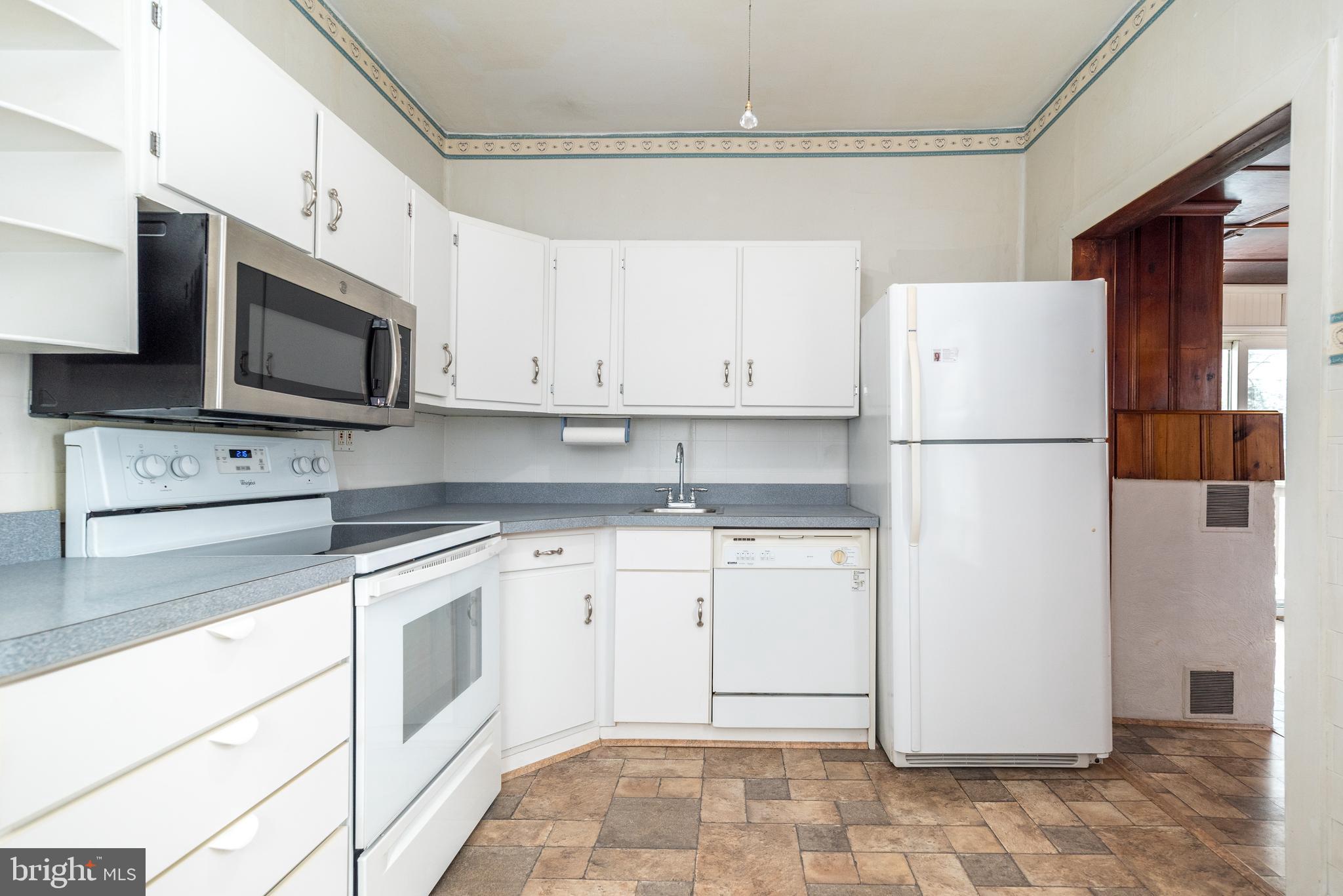 2002 Edgely Road Levittown, PA 19057 - Photo 12 of 25 a white refrigerator freezer sitting in a kitchen with stainless steel appliances granite countertop cabinets and a refrigerator