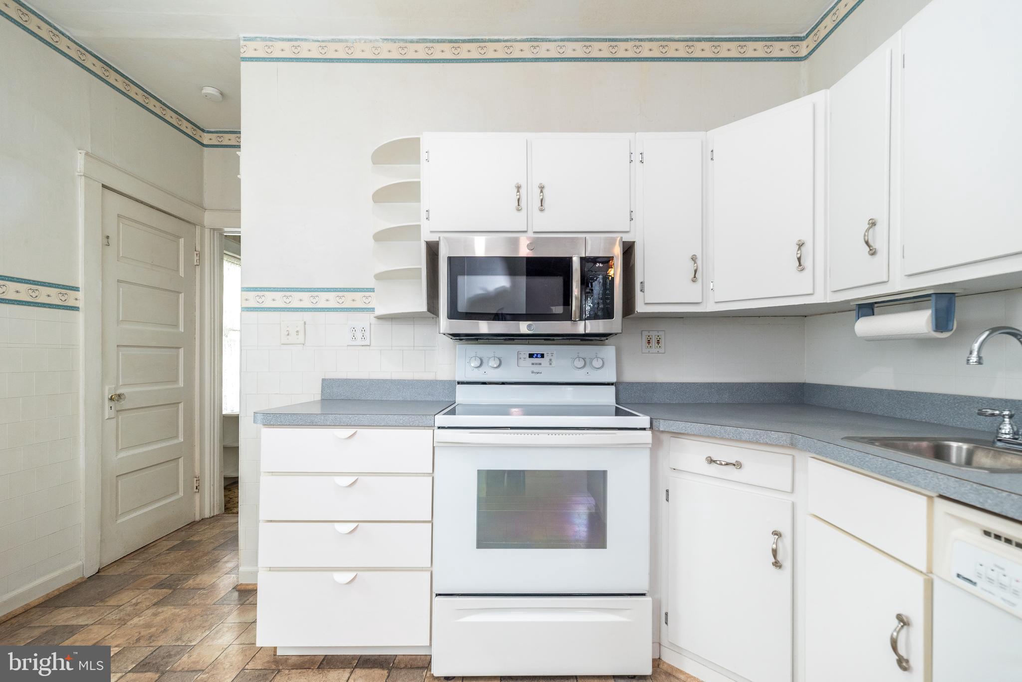 2002 Edgely Road Levittown, PA 19057 - Photo 13 of 25 a kitchen with granite countertop white cabinets and stainless steel appliances