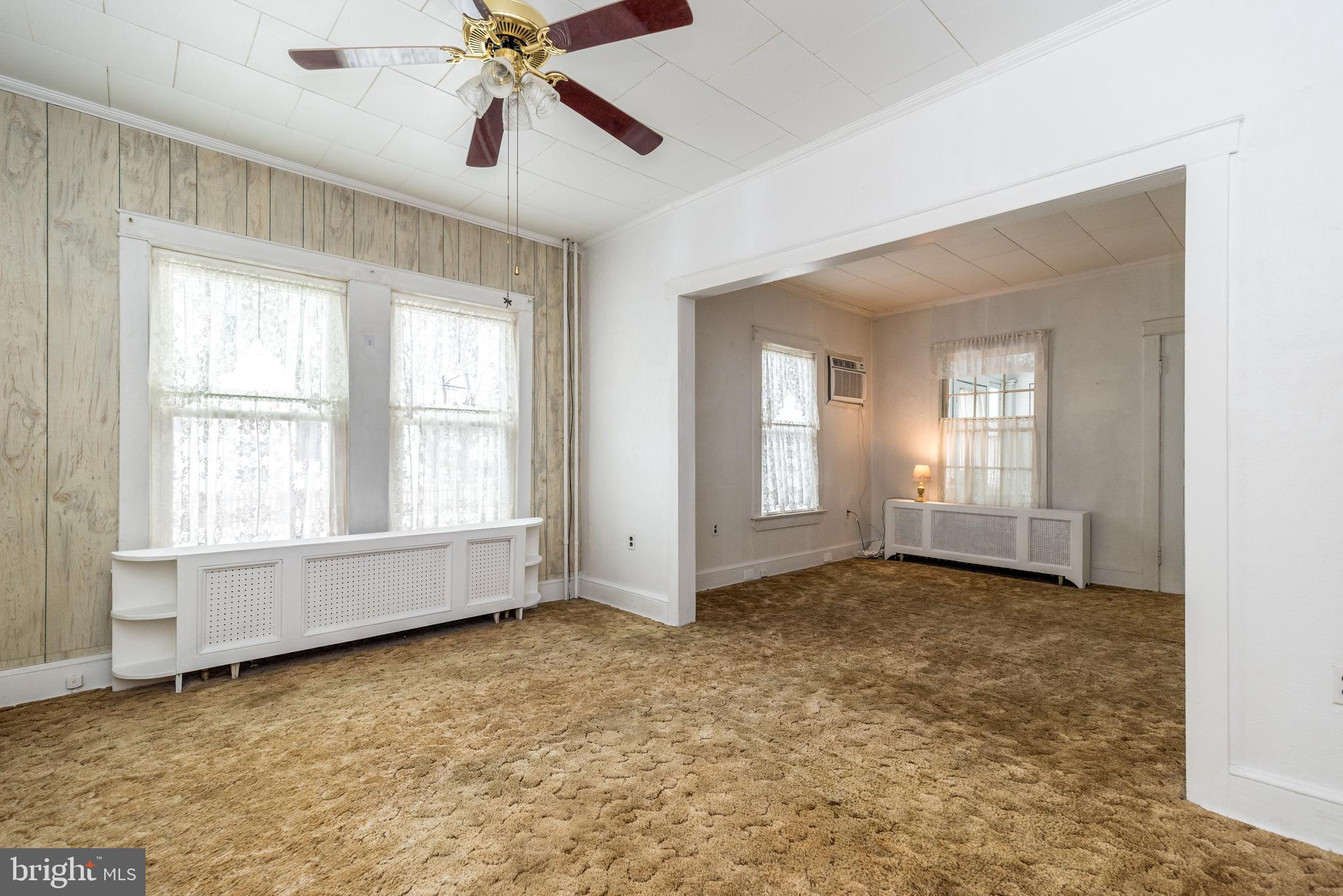2002 Edgely Road Levittown, PA 19057 - Photo 14 of 25 a view of an empty room with chandelier fan and fire place