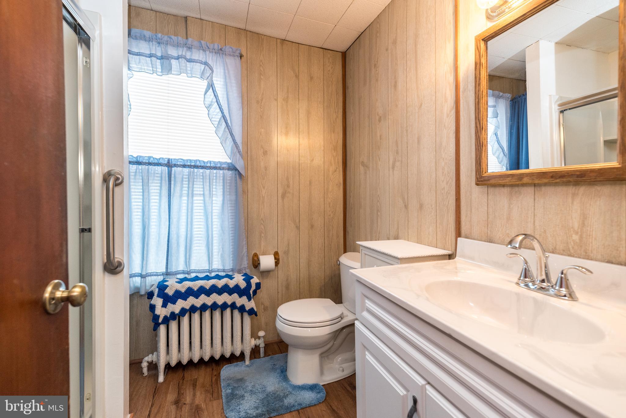 2002 Edgely Road Levittown, PA 19057 - Photo 22 of 25 a bathroom with a granite countertop sink toilet a mirror and shower