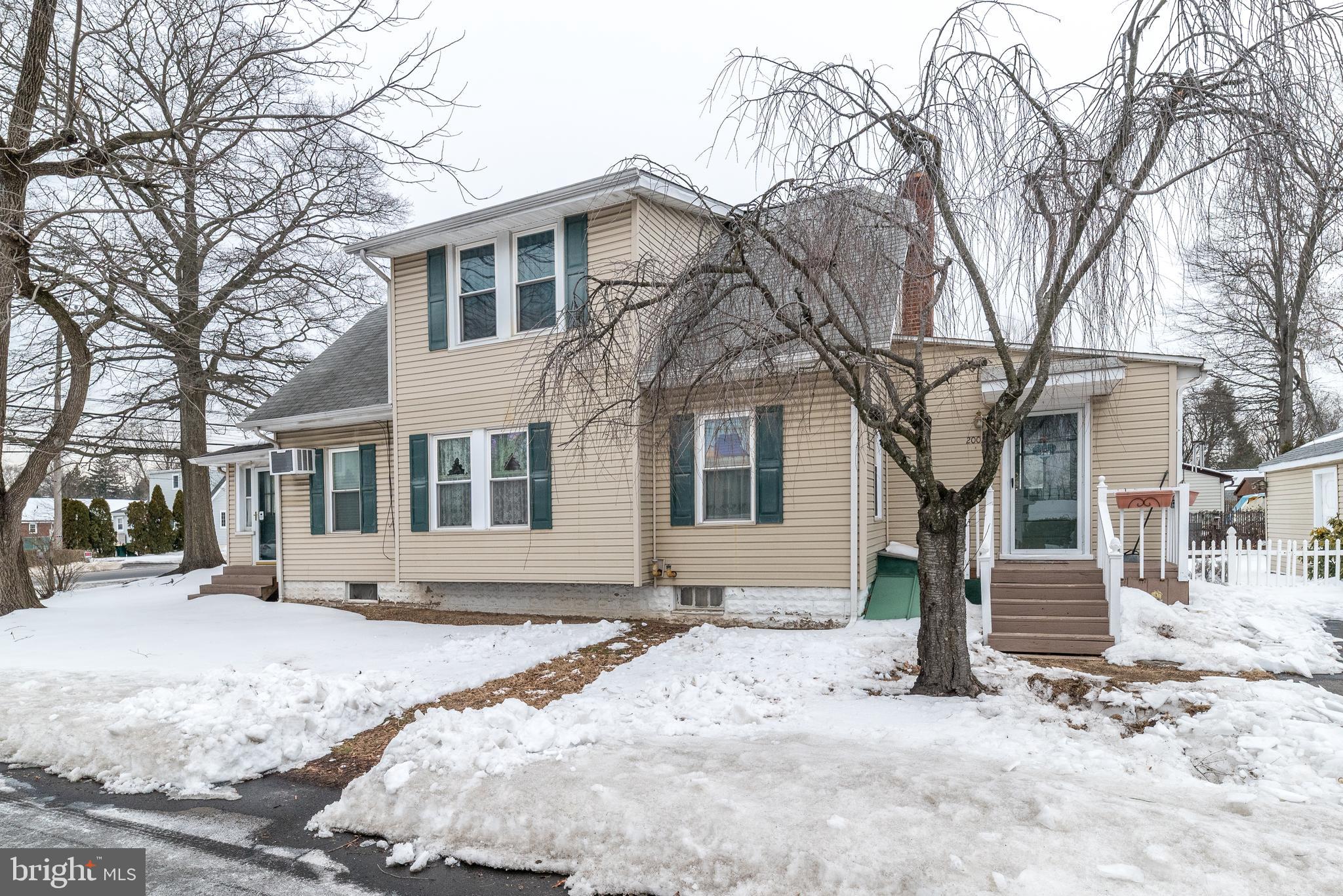 2002 Edgely Road Levittown, PA 19057 - Photo 4 of 25 a front view of a house with a yard covered in snow