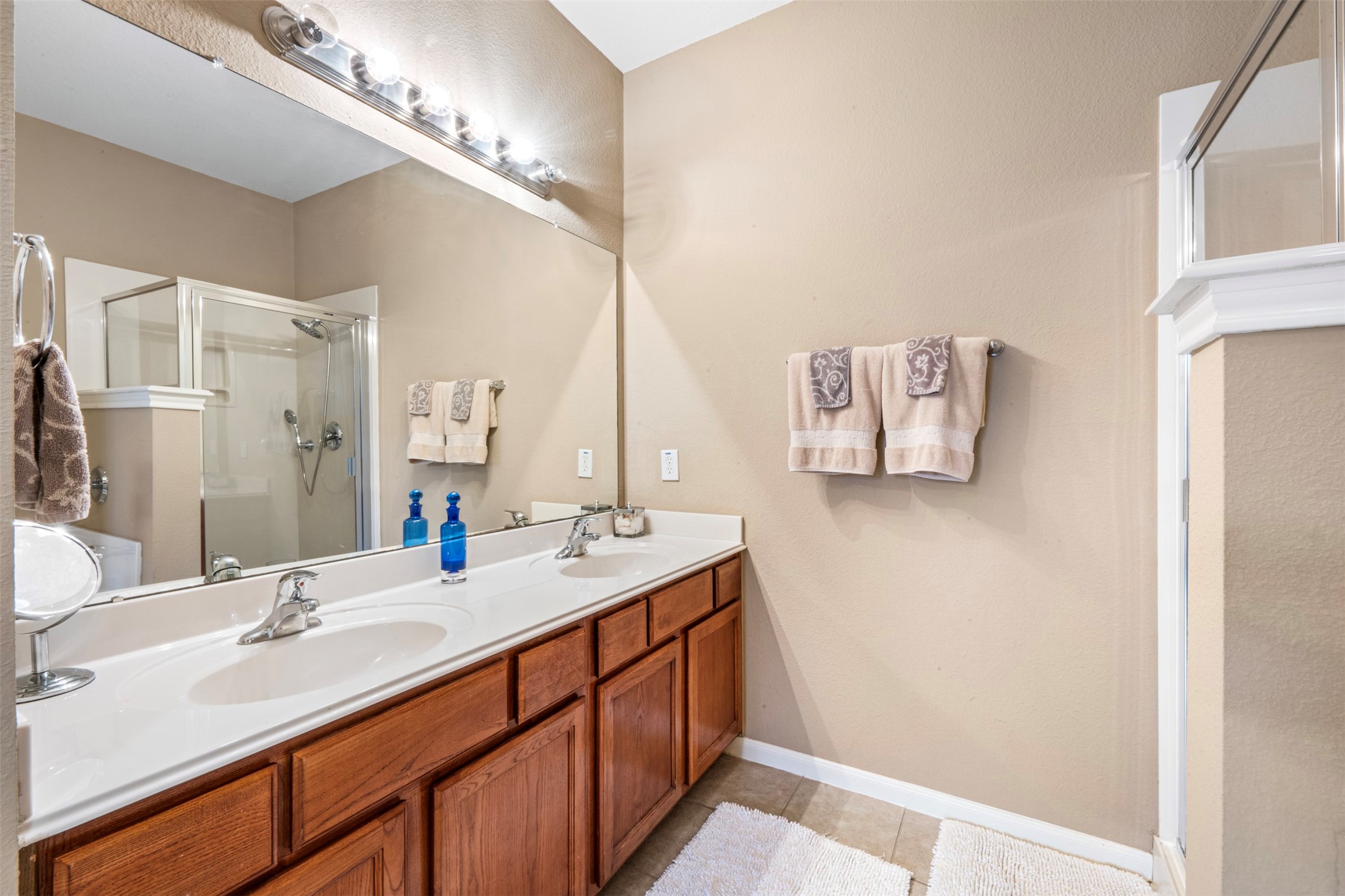 9635 Old Timber Lane Spring, TX 77379 - Photo 22 of 48 a bathroom with a double vanity sink and a mirror