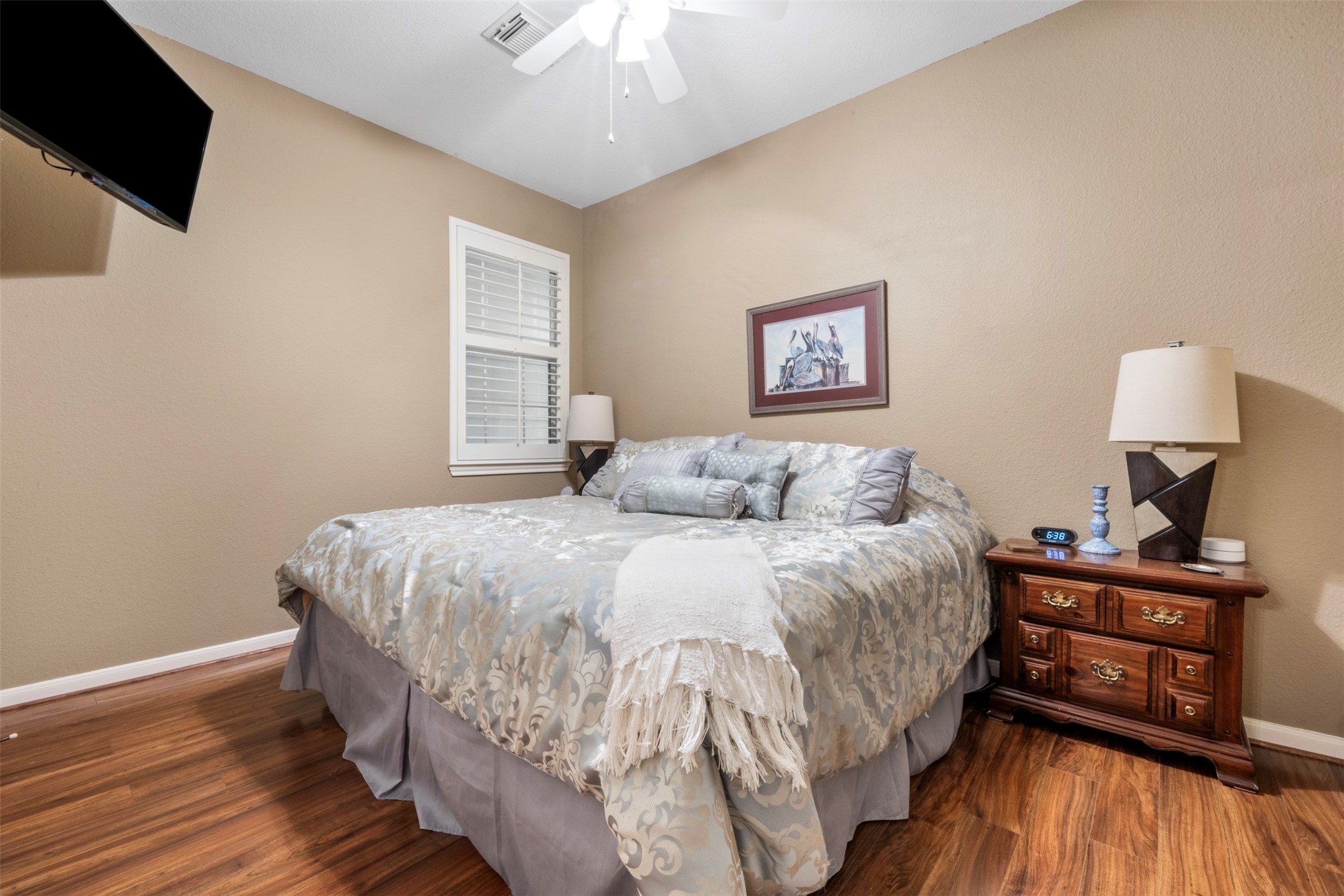 9635 Old Timber Lane Spring, TX 77379 - Photo 24 of 48 a bed sitting in a bedroom next to a window with pc on the wall