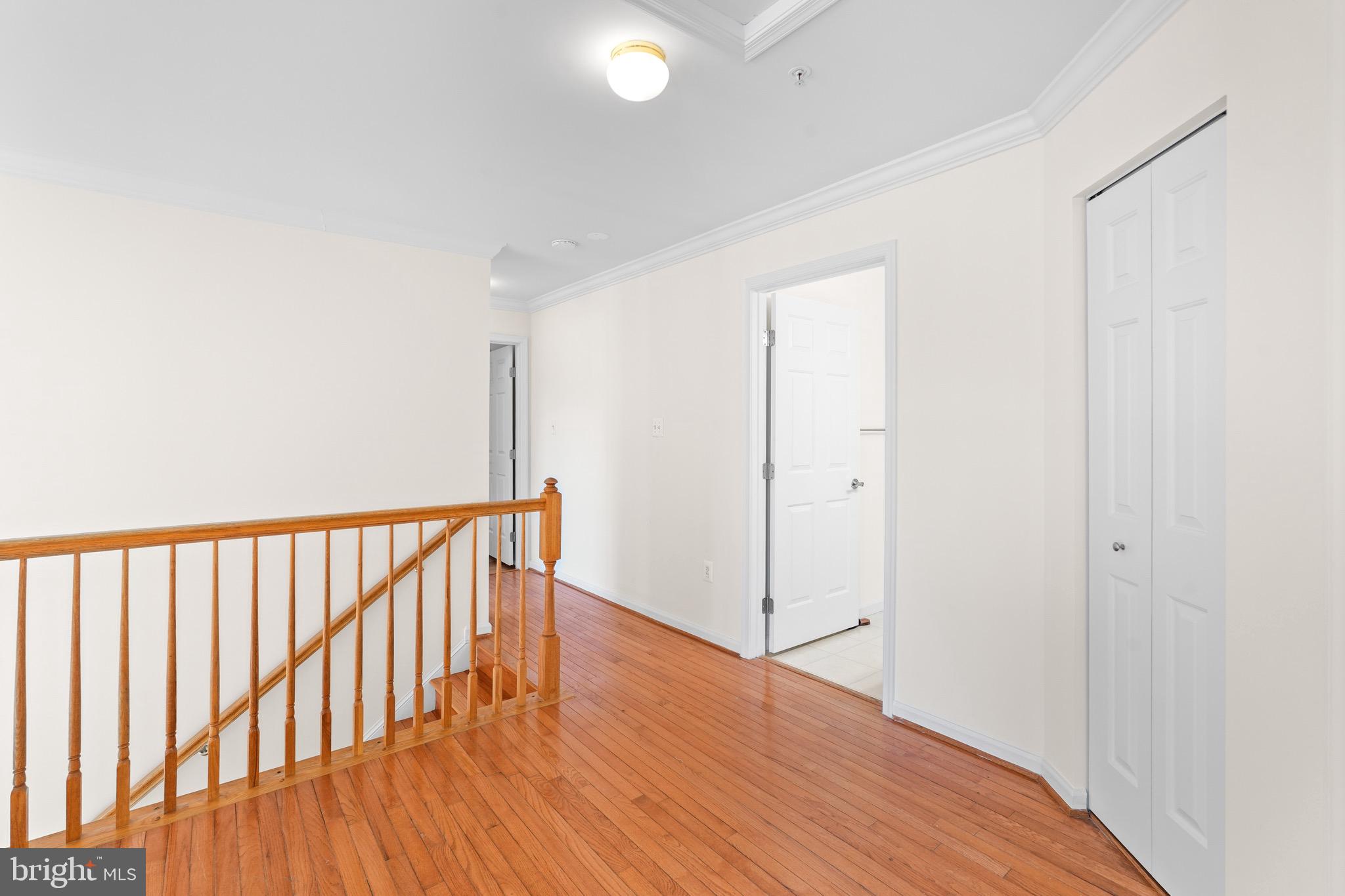 9602 Stuart Lane Clinton, MD 20735 - Photo 16 of 40 a view of hallway with wooden floor