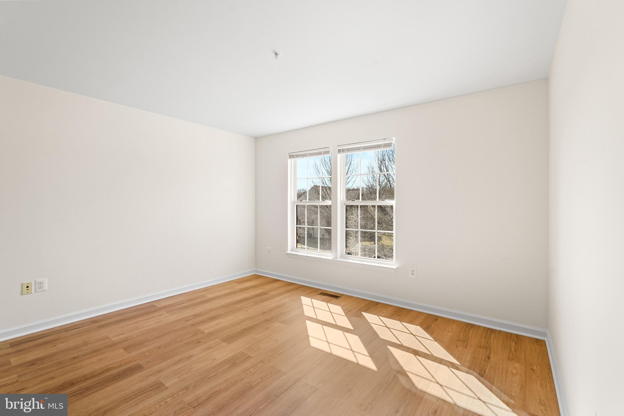 9602 Stuart Lane Clinton, MD 20735 - Photo 18 of 40 an empty room with wooden floor and windows