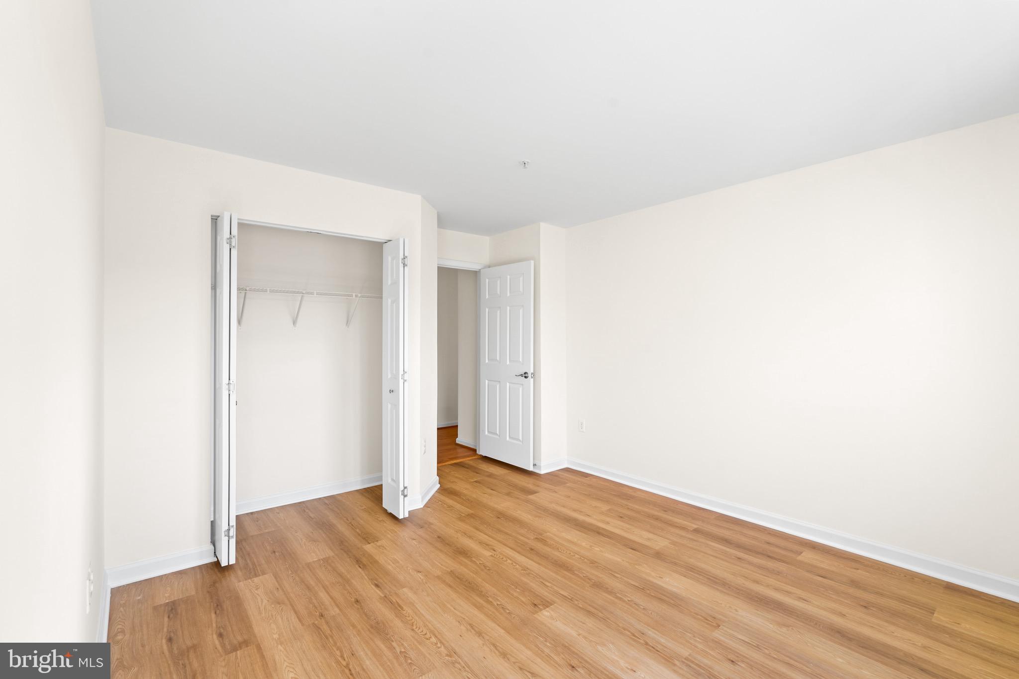 9602 Stuart Lane Clinton, MD 20735 - Photo 21 of 40 a view of empty room with wooden floor