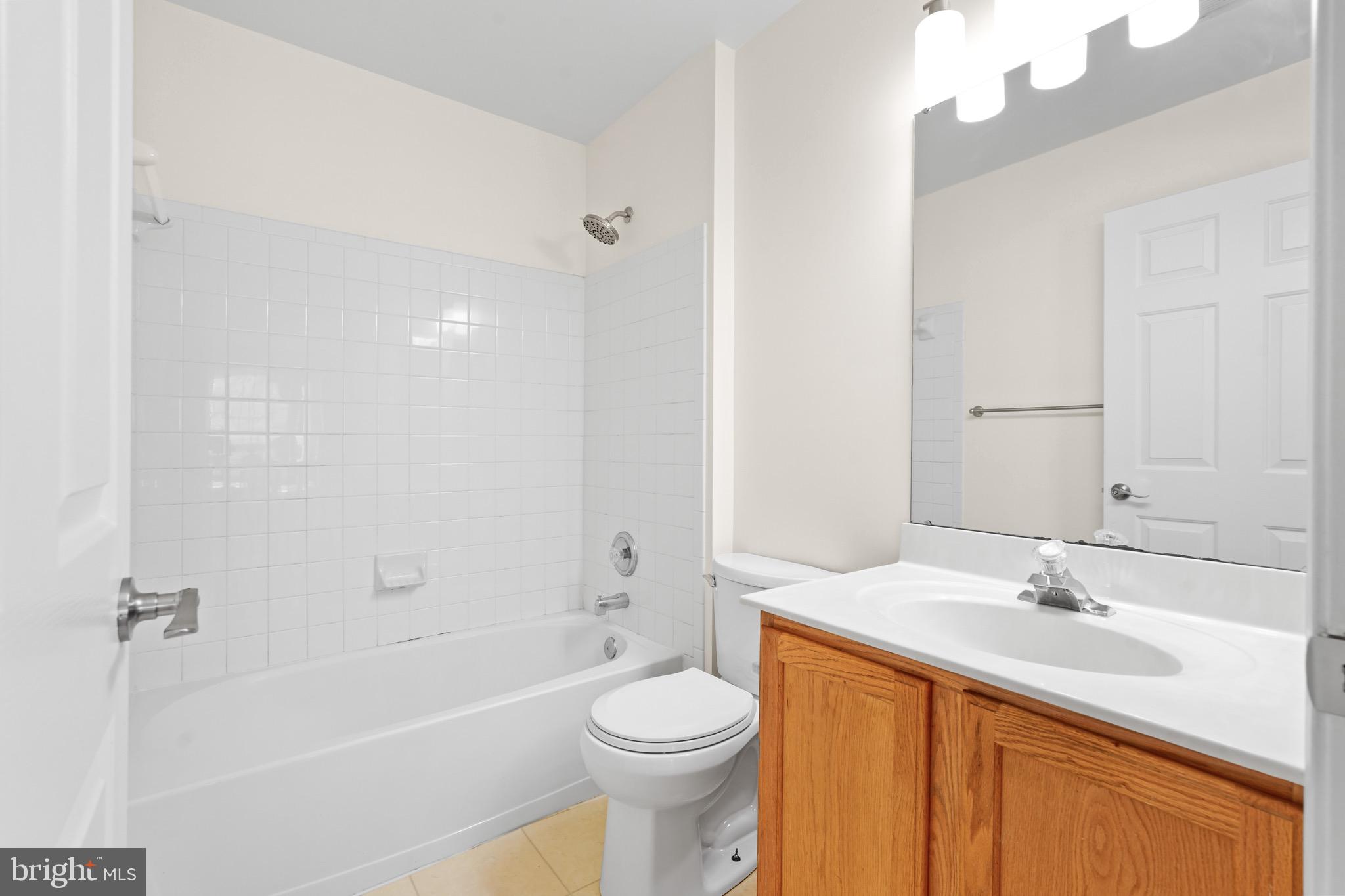 9602 Stuart Lane Clinton, MD 20735 - Photo 23 of 40 a bathroom with a sink toilet and a bathtub