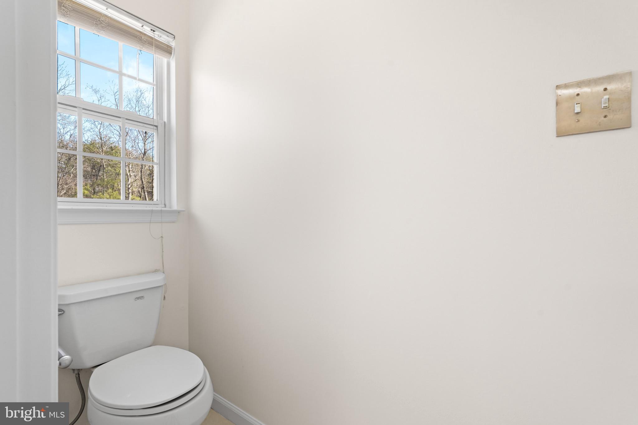 9602 Stuart Lane Clinton, MD 20735 - Photo 24 of 40 a white toilet sitting next to a window
